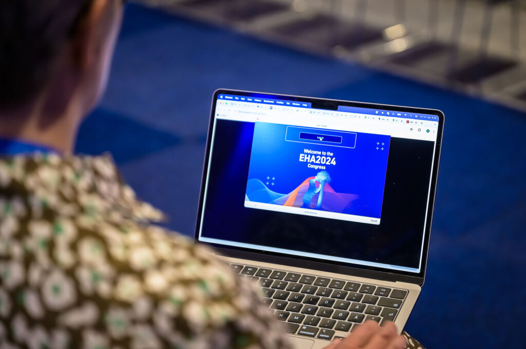 An attendee logging in to the EHA2024 event website on a laptop.