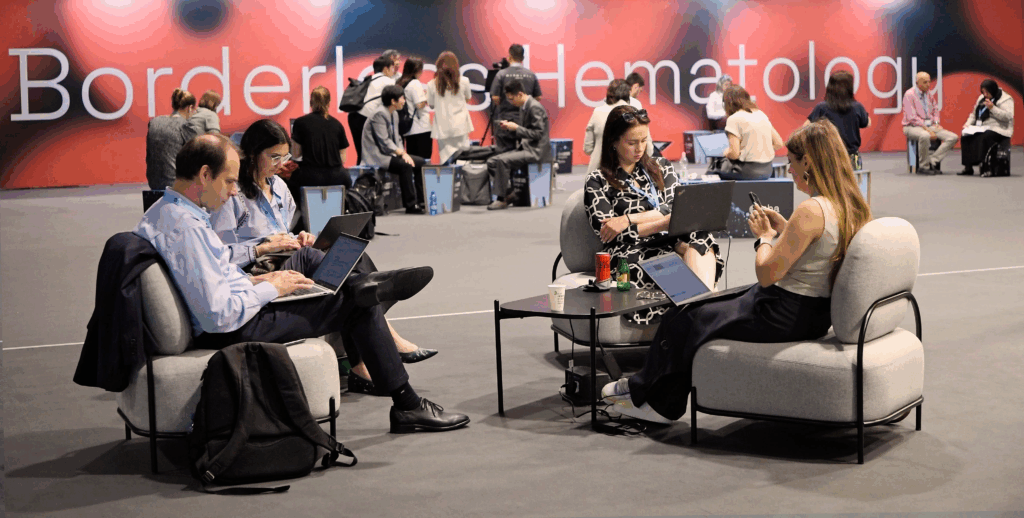 Seated delegates working during the EHA2025 Congress.